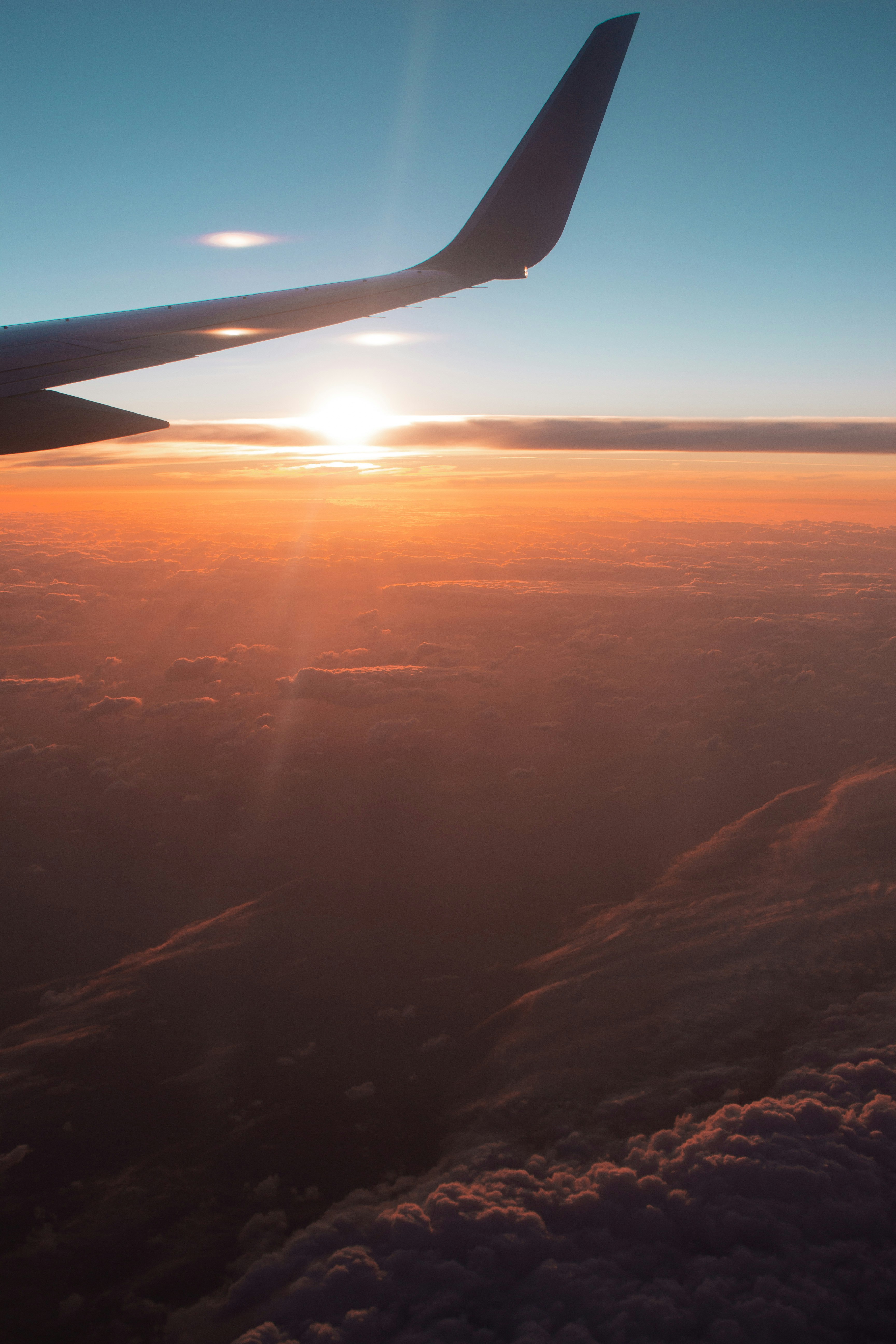 Photo of airplane wing above the clouds